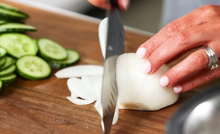 Slice the cucumbers and onions